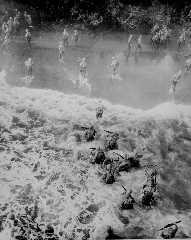 world war II soldiers running out of the surf onto the beach